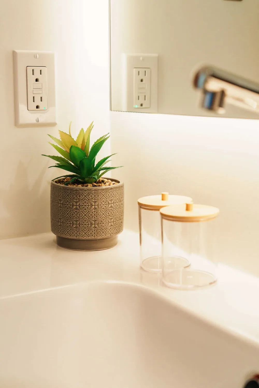 Clean bathroom vanity with warm orange towels at Bruno Petite