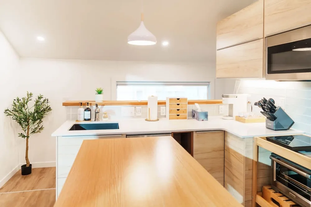 Warm wood kitchenette and dining counter inside Bruno Petite